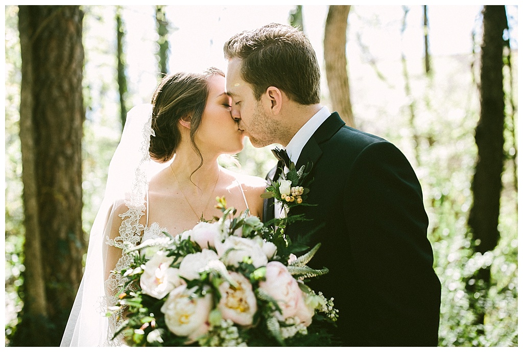 Bride and groom kissing at a private moment after the wedding